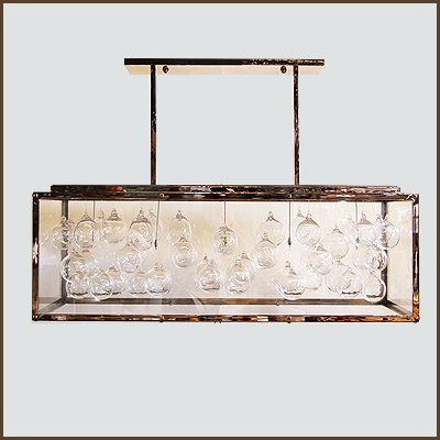 A Modern Hanging Light Fixture Featuring a Clear Glass Ball